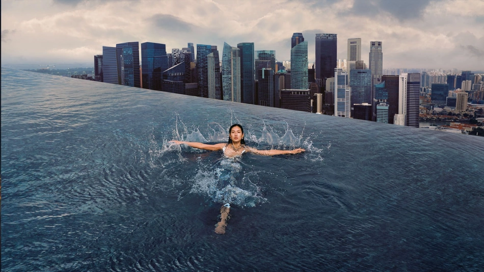 Rooftop pool overlooking Marina Bay skyline at sunset