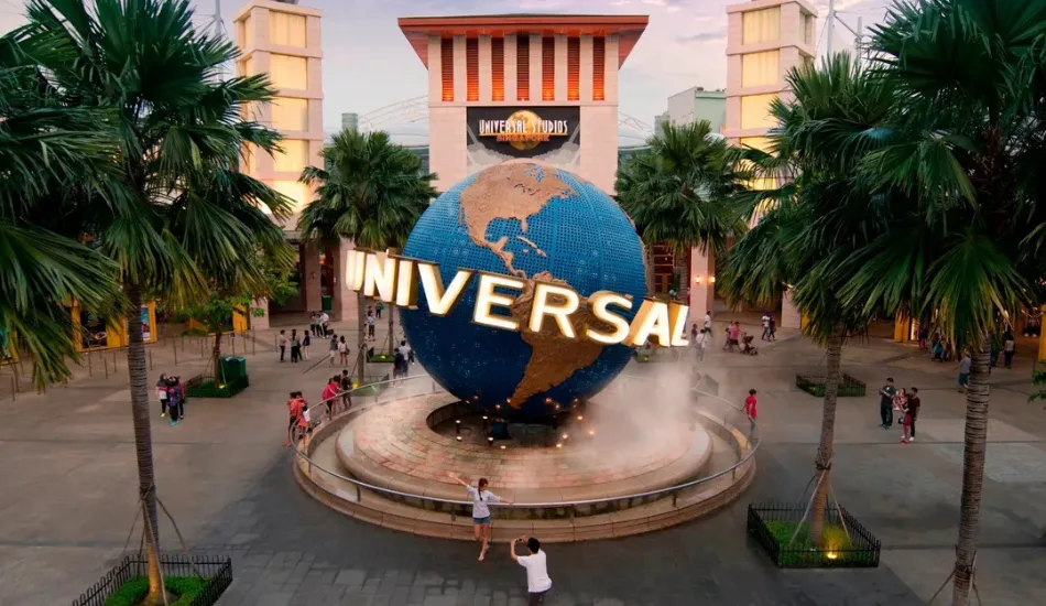 Universal Studios Singapore globe entrance with visitors on a sunny day