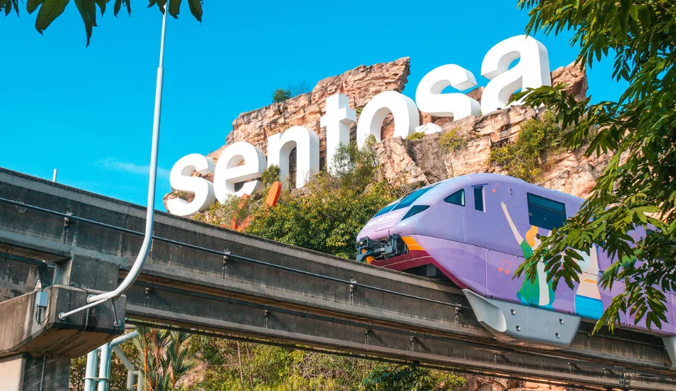 Sentosa Express monorail arriving at Resorts World station with Universal Studios Singapore in background