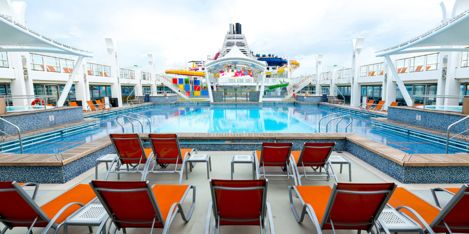 Swimming pool and sunbeds on the main deck of Genting Dream Cruise ship