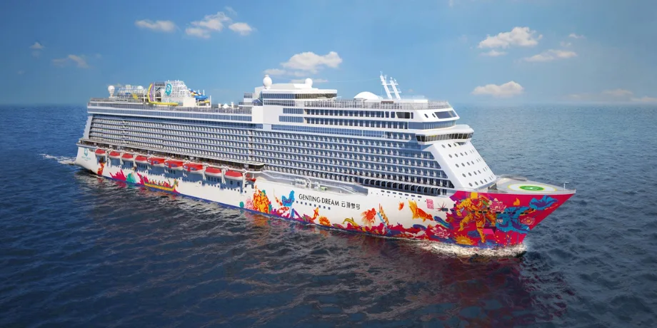 Genting Dream cruise ship at sea with colourful hull artwork on a sunny day near Singapore