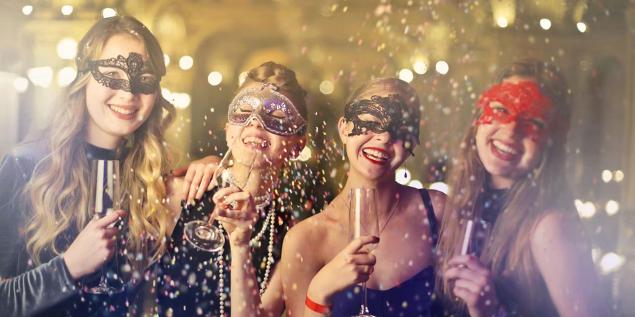 Group of women enjoying a masquerade party with confetti on Ovation of the Seas cruise Group of women enjoying a masquerade party with confetti on Ovation of the Seas cruise