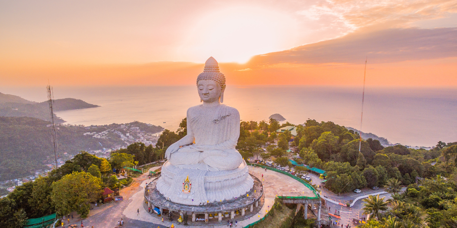 Aerial view of Big Buddha statue in Phuket at sunset overlooking the ocean