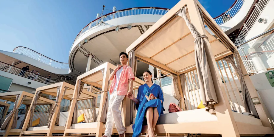 The Palace sun deck cabanas on Genting Dream—exclusive area for suite guests